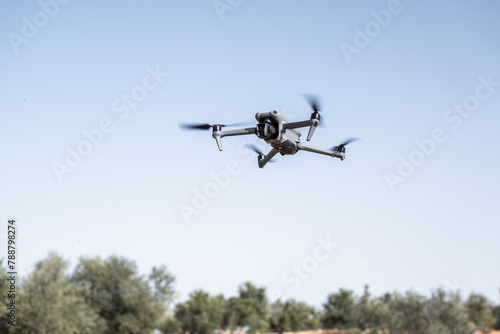 Skilled pilot maneuvers drone, showcasing aerial photography, warm nature, and advanced technology.