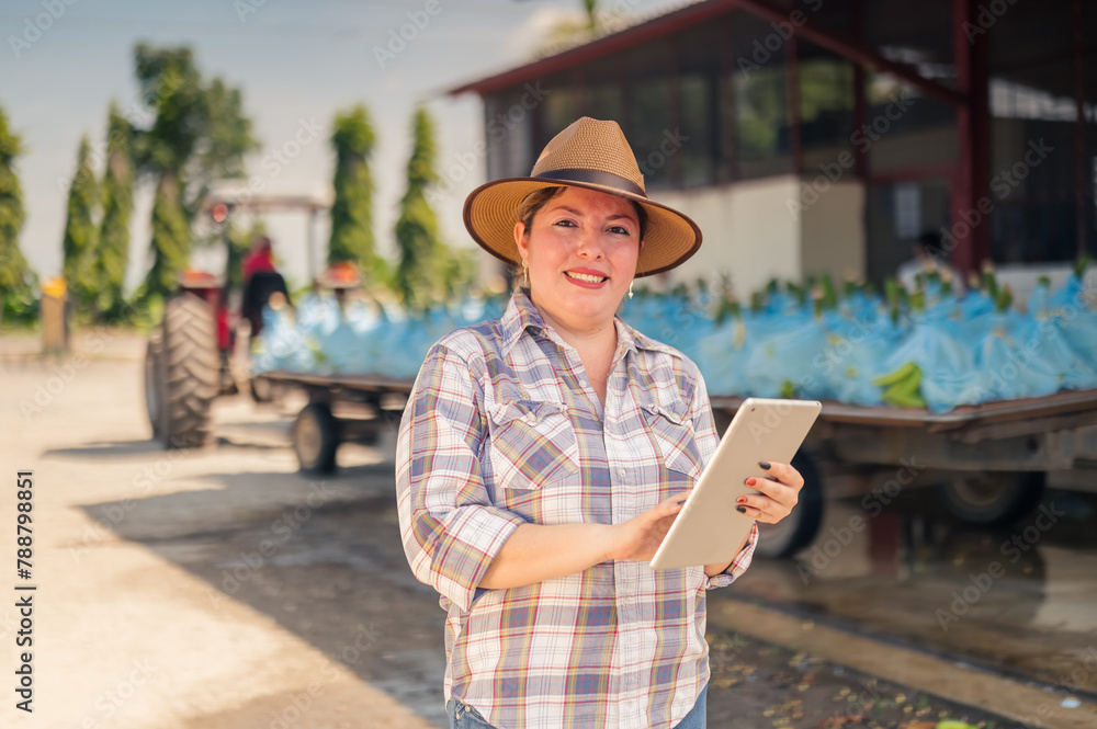 Portrait of a beautiful agriculture woman standing in front of the banana packing house.