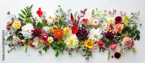 Artistic arrangement comprised of different flowers and foliage laid flat, symbolizing the essence of spring.
