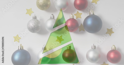 Ornaments and gold stars around paper Christmas tree