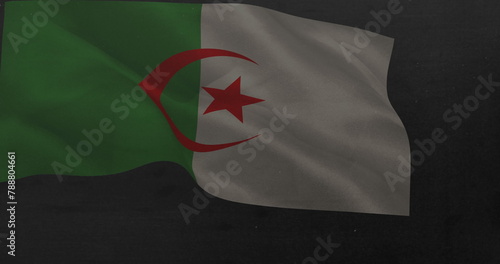 A flag with green and white sections and red crescent and star is waving
