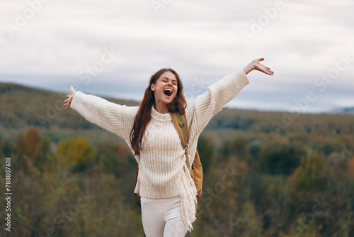 Mountain Adventure: Smiling Woman on Cliff, Backpack and Sweater, Enjoying Freedom and Nature