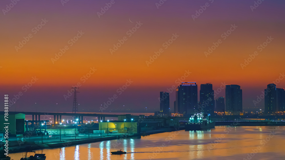 Panoramic view of skyscrapers cityscape with illuminations and street lights on, at sunset, evening, Abu Dhabi, United Arab Emirates 