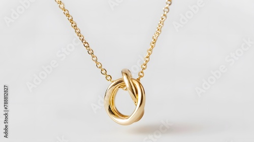 A minimalist gold necklace consisting of a single perfectly formed loop capturing the essence of elegance in its simplicity The necklace hangs against a stark white background