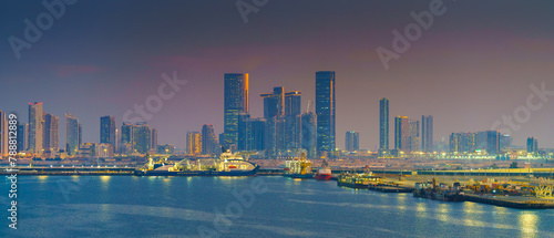 Abu Dhabi  United Arab Emirates - Jan 10 2024  Panoramic view of skyscrapers cityscape with illuminations and street lights on  at sunset  evening  Abu Dhabi  United Arab Emirates 