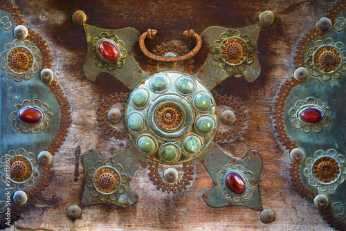 Close-up view of the bronze decoration element with floral pattern of an antique chest with inlaid crystals, Doha, Qatar