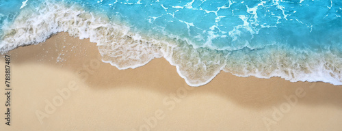 Foamy waves kiss the sandy shore in a serene beach setting. The tranquil ocean gently laps at the beach, creating a peaceful panorama with copy space.