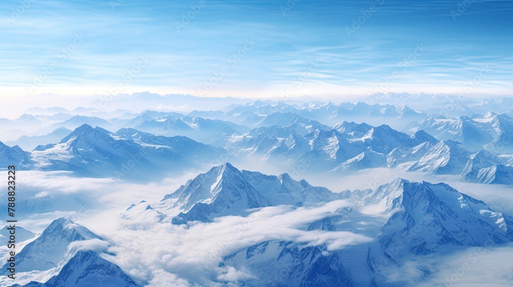 This is a beautiful landscape photograph of a mountain range. The mountains are covered in snow and the sky is a clear blue. This is a beautiful landscape photograph of a mountain range. The mountains are covered in snow and the sky is a clear blue.