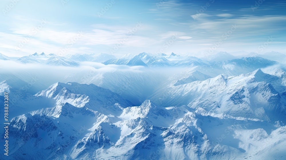 Fototapeta premium This is a beautiful landscape photograph of snow-capped mountains. The image is taken from a high angle, and the mountains are in the distance.