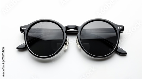 Stylish sunglasses with a black plastic frame, isolated on a white background and viewed from above