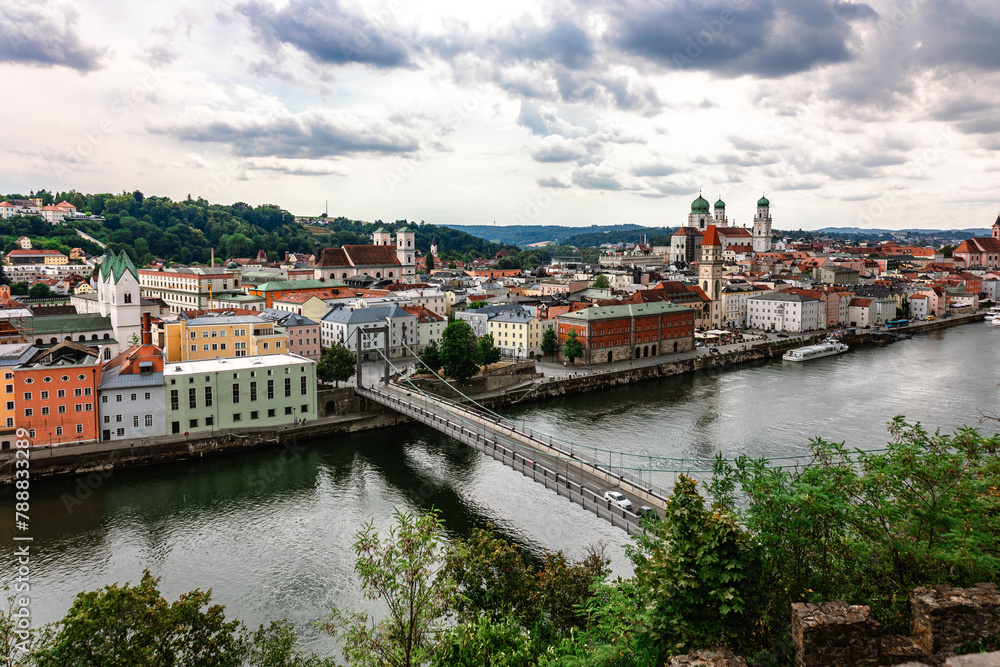 Panoramic view of Passau. Top view of suspension bridge. Aerial skyline of old town with beautiful reflection in Danube river, Bavaria, Germany.
