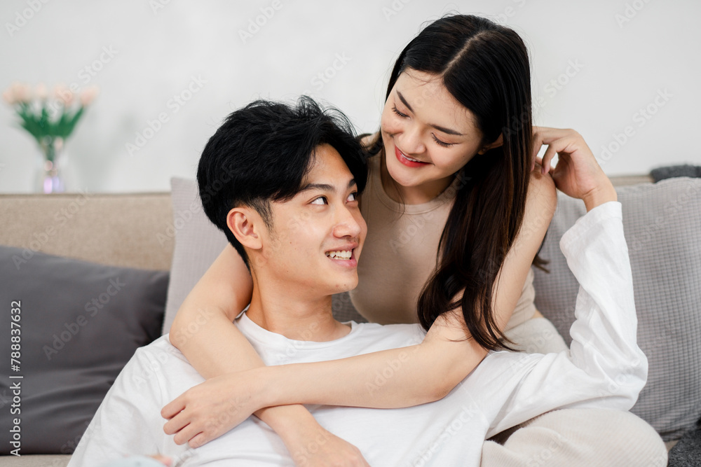 Affectionate scene where a couple shares a tender laugh, with the woman playfully touching her partner's ear, highlighting their close bond. Affectionate scene where a couple shares a tender laugh, with the woman playfully touching her partner's ear, highlighting their close bond.