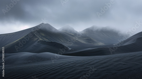 Peaceful black desert landscape with mountains in the distance under a cloudy sky