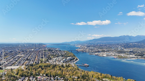 Beautiful aerial view of the skyline of Vancouver and North Burnaby next to the Burrard Inlet during a spring season in British Columbia, Canada © StandbildCA