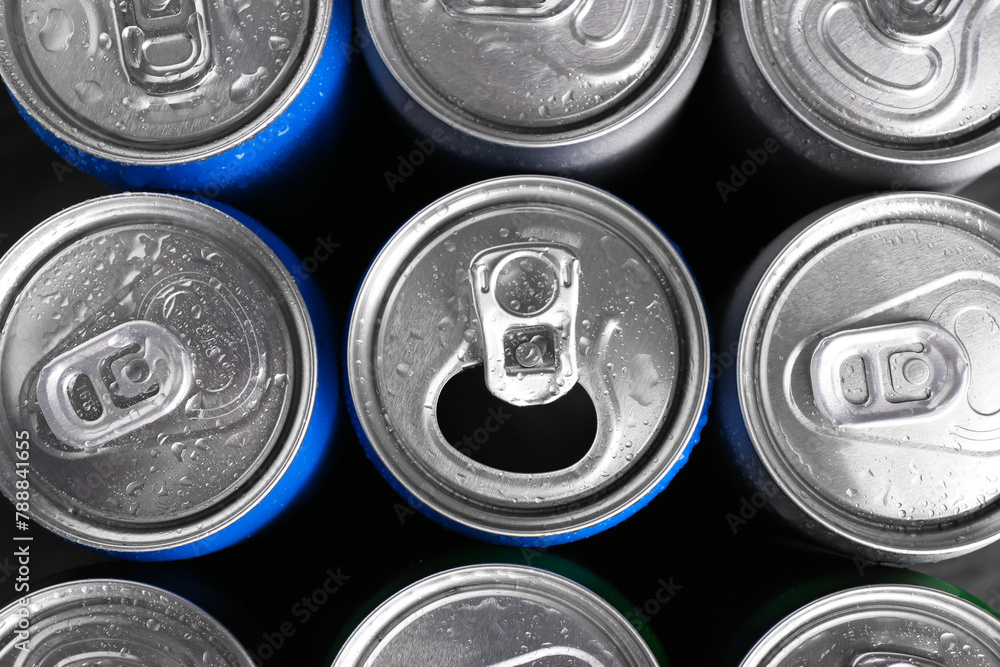 Energy drinks in wet cans as background, top view. Functional beverage Energy drinks in wet cans as background, top view. Functional beverage
