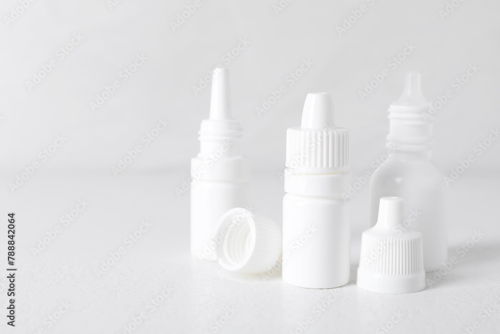 Bottles of medical drops on white background, space for text Bottles of medical drops on white background, space for text