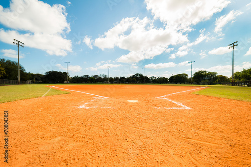 Empty Softball Field under blue sky with scattered clouds. © Eric Hood