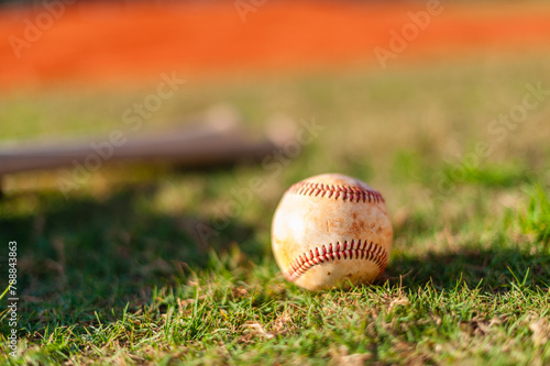 Well worn baseball on grass field