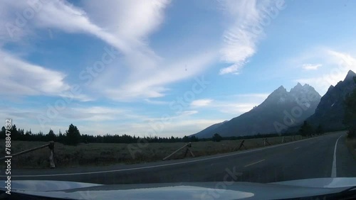 Driving southbound on Jenny Lake road in view of the Cathedral Group mountains in Grand Teton National Park Wyoming photo