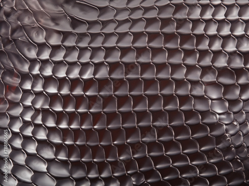 brown leather snake texture as background, close view © mansum008