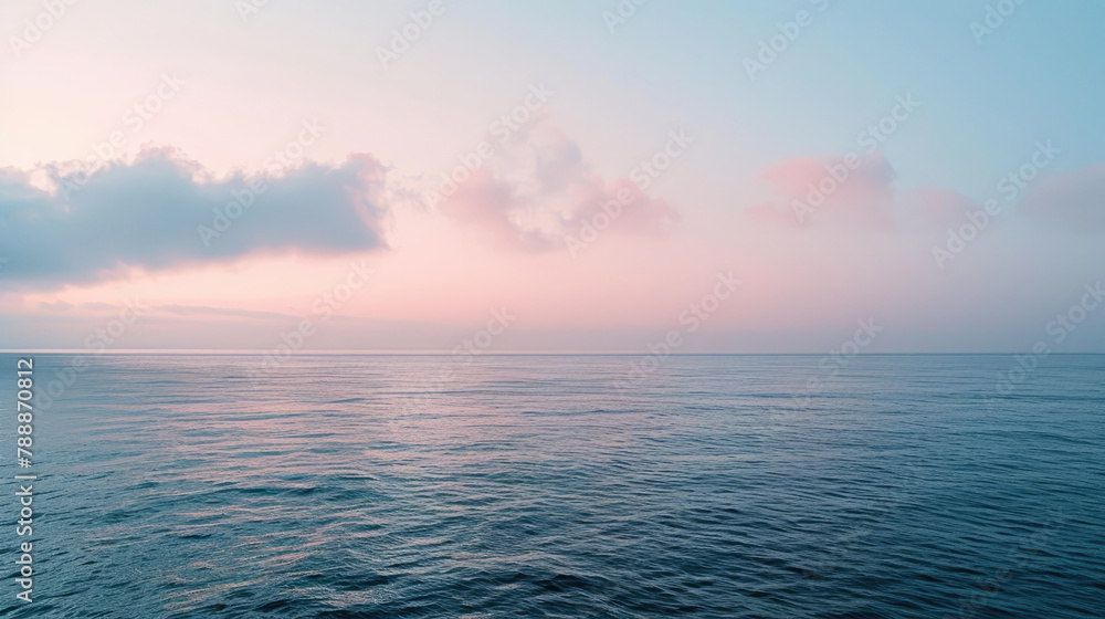 Gentle dawn over tranquil sea with minimalist clouds for serene panoramic background