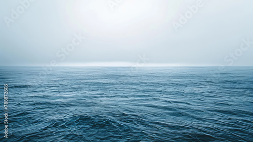 Peaceful ocean expanse under overcast skies in soothing shades photo