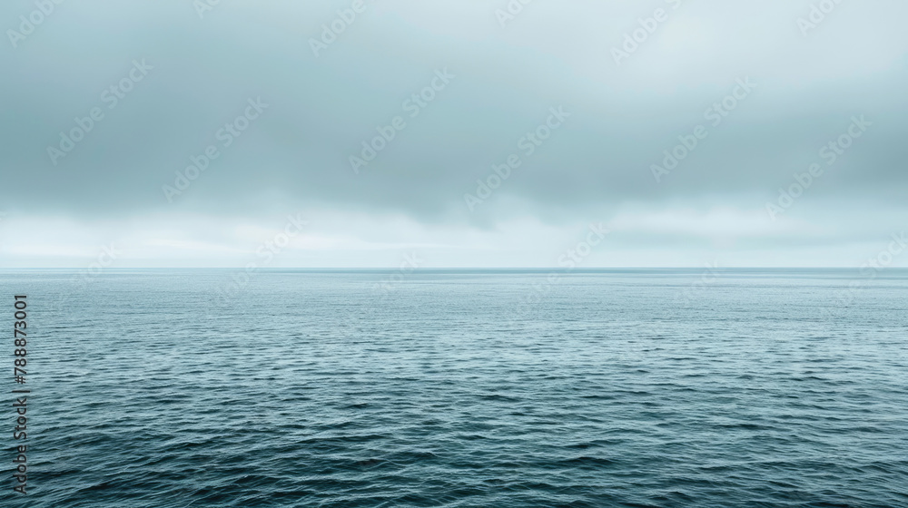Fototapeta premium Peaceful ocean expanse under overcast skies in soothing shades