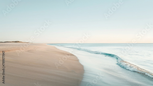 Beautiful sunrise over tranquil beach with gentle waves and clear skies