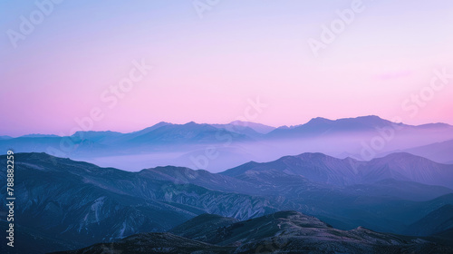 Serene mountain silhouettes cast in soothing purple hues of dusk