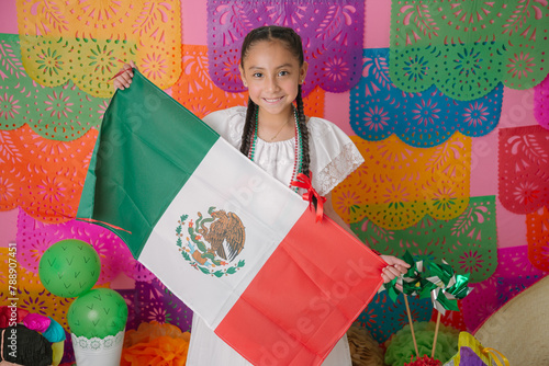 Young Girl Celebrating with Mexican Flag and Traditional Dress