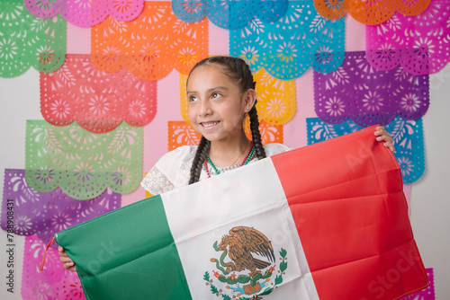 Dreamy Girl with Mexican Flag Over Colorful Traditional Backdrop, ready to celebrate the national holidays of Independence in September, Revolution Cinco de Mayo