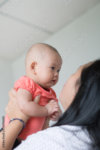 Asian mother holding her infant girl