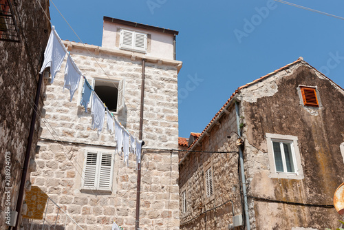 Underwear washing hang out to dry between old stone European buildings