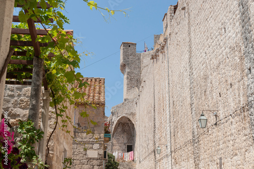 Inside wall of medieval city high wall leads to steps washing hanging in sun drying © Brian Scantlebury