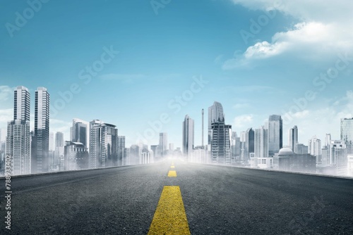 Empty asphalt road towards modern city