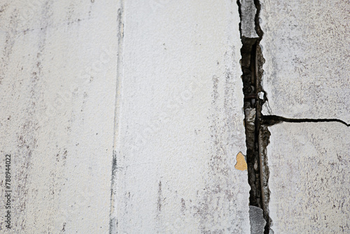 Cracks in the wall of white cement