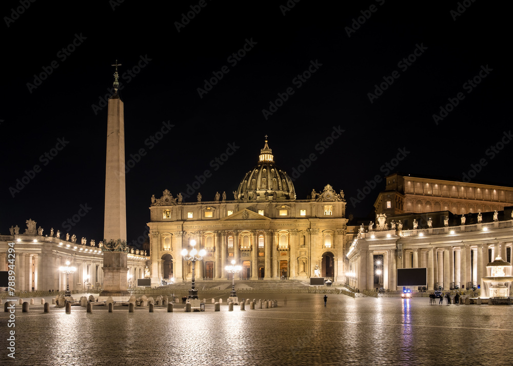 Nighttime vista of Saint Peter's Square in Vatican City, the papal enclave in Rome, showcasing the iconic Vatican obelisk at its center, framed by the striking backdrop of St. Peter's Basilica.