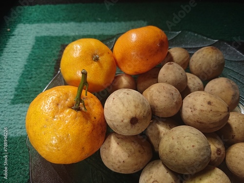 Fresh duku and orange fruit.
 photo