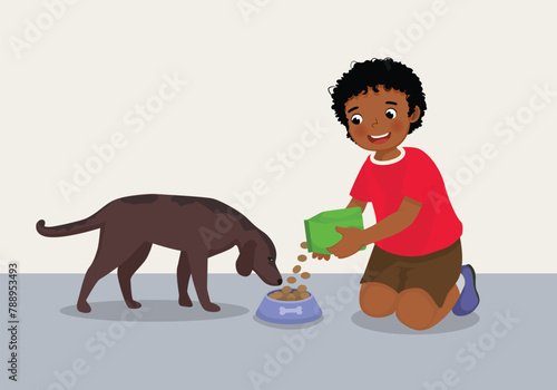 Cute little African boy feeding her dog pet with animal food