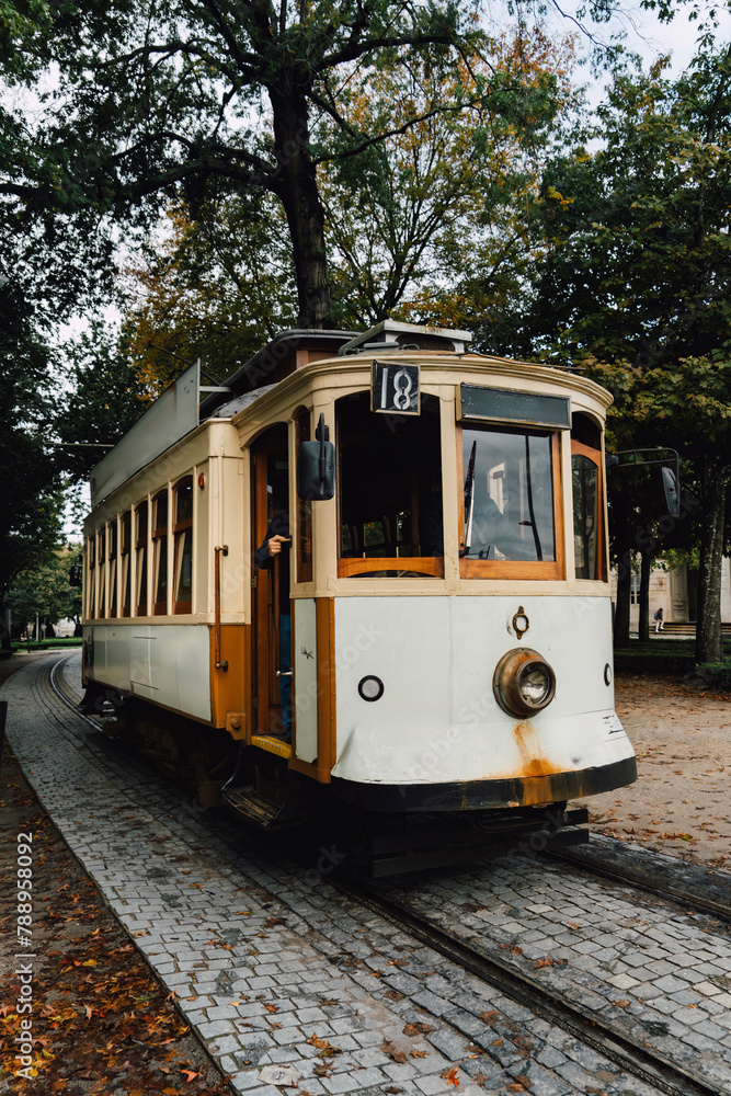 Street view with the famous retro tourist streetcar tram in the old town of Porto, Portugal. Traditional Tram