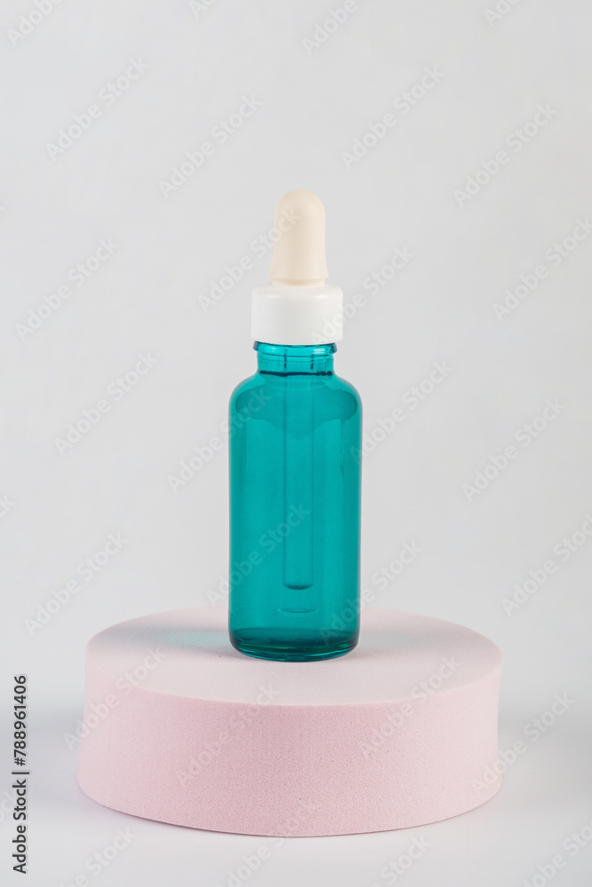 Green glass cosmetic bottle, Skin care or sunscreen cosmetic with stylish props on white background. Green glass cosmetic bottle, Skin care or sunscreen cosmetic with stylish props on white background.