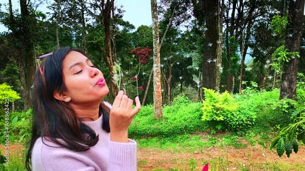 beautiful young woman blowing on the dandelion in the evening against the background of the Jungle. 4K slow motion video. beautiful young woman blowing on the dandelion in the evening against the background of the Jungle. 4K slow motion video.