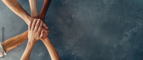 A group of people are holding hands in a circle, team work concept, working together