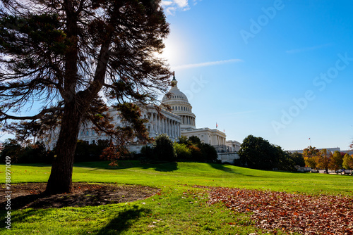 A tranquil morning scene of the Capitol Building with the sun over its dome in Washington, DC.