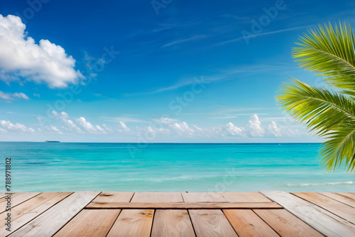 beach with sky,A wooden floor overlooking a clear blue sea with a palm tree.