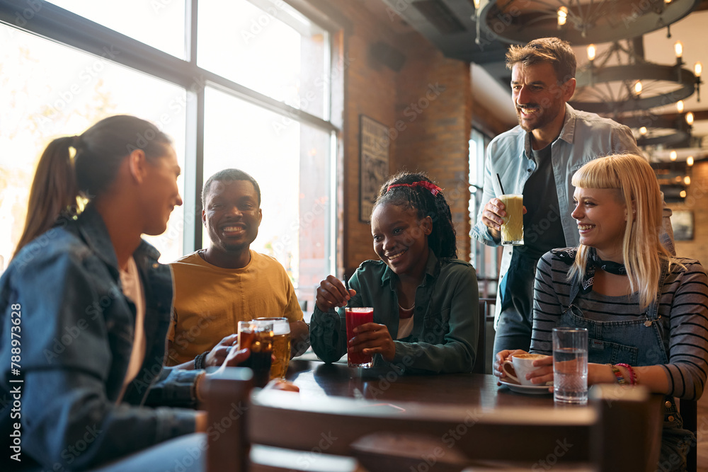 Multiracial group of happy friends gathering in bar. Multiracial group of happy friends gathering in bar.
