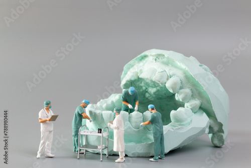 Miniature people ,A dentist displaying dental models and plaster orthodontic models