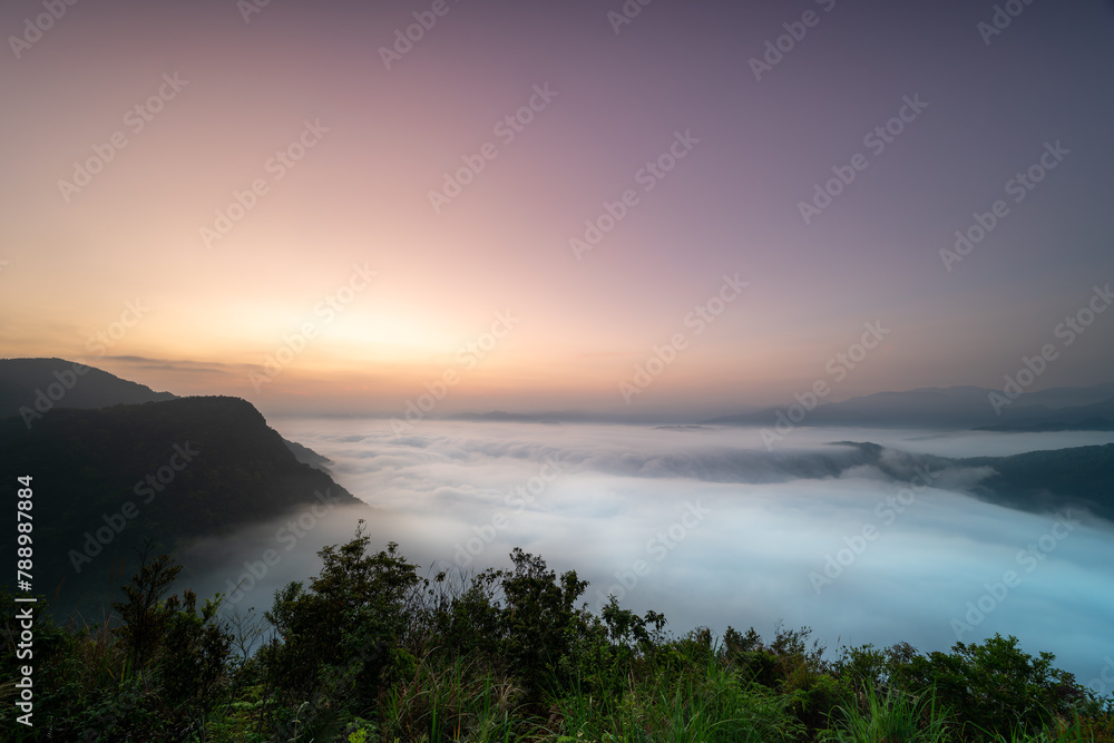 The sea of clouds before sunrise gives people a feeling of energy. View of the mountains surrounding Emerald Reservoir. Xindian District, Taiwan.
