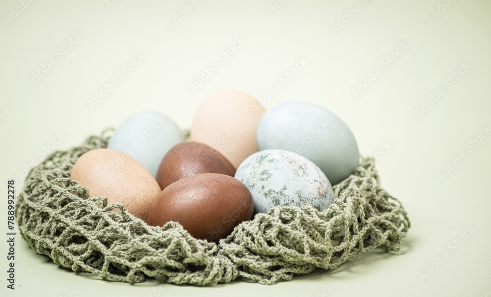 blue-gray and brown chicken eggs for Easter on a light green background. blue-gray and brown chicken eggs for Easter on a light green background.