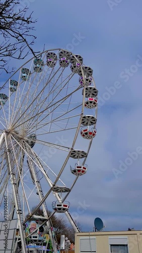 Close up of ferris wheel at day time in summer with blue sky photo